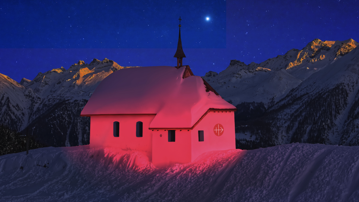 Eine rot angeleuchtete Kirche in den Bergen