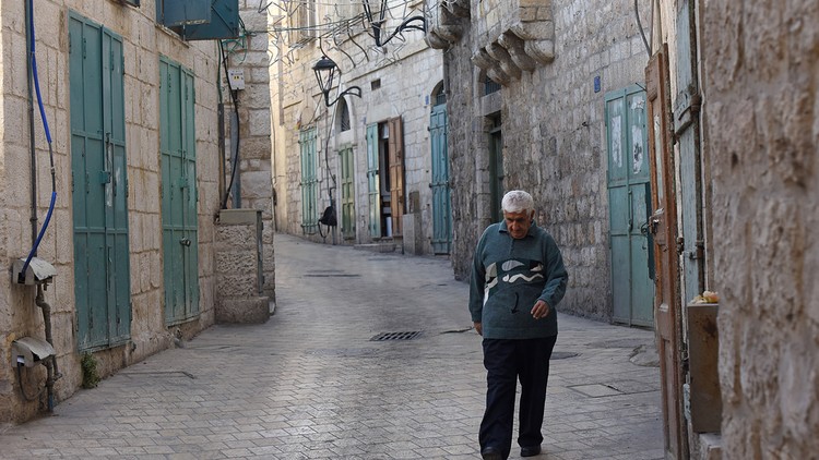 Ein Mann läuft eine Strasse in Bethlehem entlang.