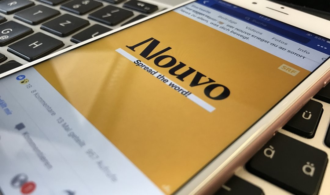 Symbolbild mit Mobiltelefon, auf dem Bildschirm Logo von «Nouvo»